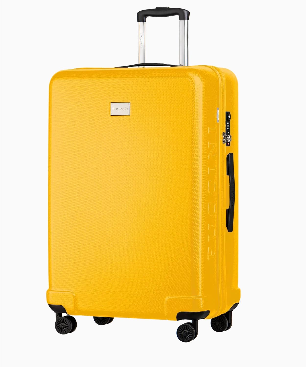 Žltý veľký tvrdý kufor s voštinovým povrchom